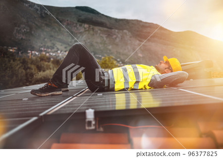 Workers relaxes above solar panel for electricity 96377825