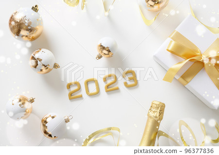 New Year 2023 festive composition with number of year, gift, baubles. 96377836