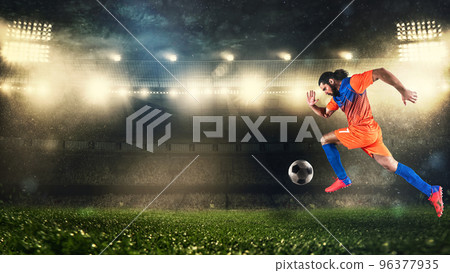 Soccer player in orange and blue uniform sprinting fast with the ball at the stadium Soccer player in orange and blue uniform sprinting fast with the ball at the stadium 96377935