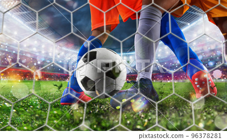 Soccer player kicks the ball to reach the goal 96378281