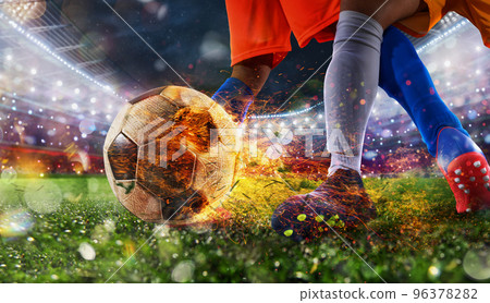 Soccer players with fiery soccerball during the match 96378282