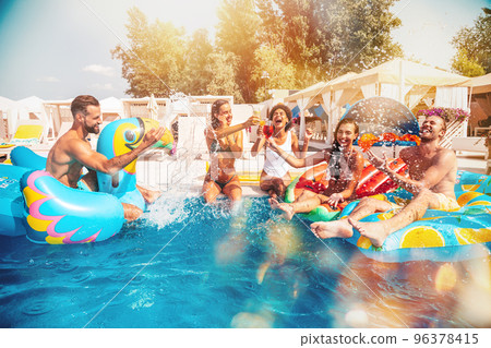Group of friends in swimsuit enjoy in a swimming pool 96378415