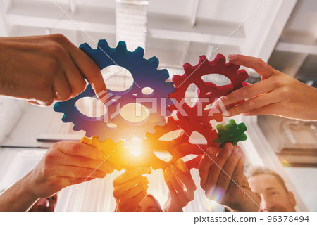 Business team connect pieces of gears like a teamwork and partners Business team connect pieces of gears like a teamwork and partners 96378494