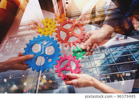 Business team connect pieces of gears like a teamwork and partners Business team connect pieces of gears like a teamwork and partners 96378495