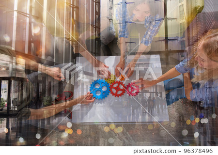 Business team connect pieces of gears like a teamwork and partners Business team connect pieces of gears like a teamwork and partners 96378496