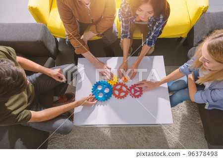 Business team connect pieces of gears like a teamwork and partners Business team connect pieces of gears like a teamwork and partners 96378498