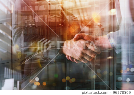 Handshaking of business person in office as teamwork and partnership Handshaking of business person in office as teamwork and partnership 96378509
