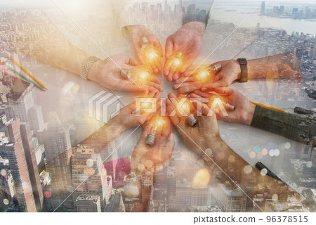 Teamwork and brainstorming concept with businessmen that share an idea with a lamp Teamwork and brainstorming concept with businessmen that share an idea with a lamp 96378515