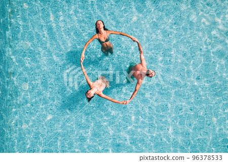 Group of friend play together in a swimming pool 96378533