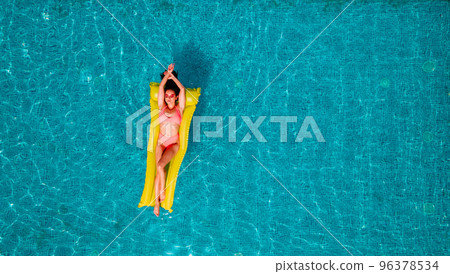 Girl in swimsuit who tan in a swimming pool Girl in swimsuit who tan in a swimming pool 96378534