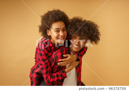Happy and carefree afro boyfriend and girlfriend play together Happy and carefree afro boyfriend and girlfriend play together 96378789