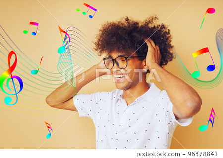 Happy afro man dances and listens to music 96378841