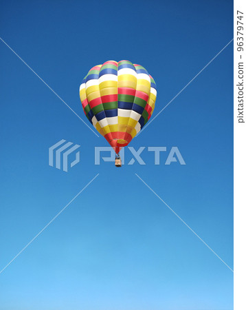 hot air balloon flying in the blue sky hot air balloon flying in the blue sky 96379747