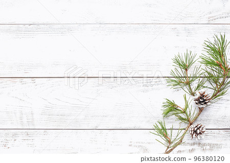 Pine tree branch on white wooden background for winter holidays designs, flat lay, copy space 96380120