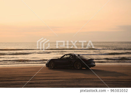 Black open car on the beach 96381032