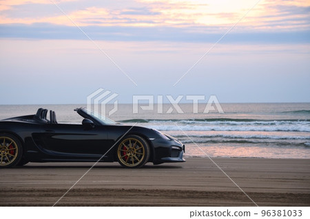 Black open car on the beach 96381033