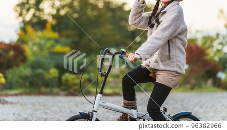 Asian woman riding a bicycle in the evening in outdoor fashion (cycling) 96382966