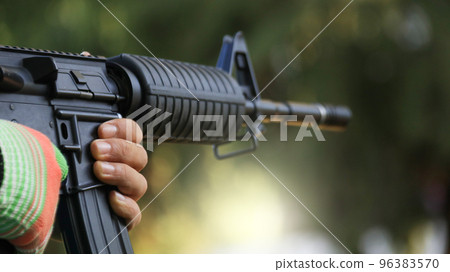 Air soft gun holding by hands in the shooting range, soft and selective focus on the gun                               96383570