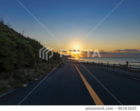 A subjective view of driving through the woods and up a slope along the coast at dawn A subjective view of driving through the woods and up a slope along the coast at dawn 96383685