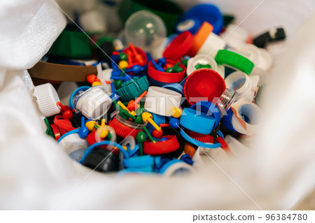 Close-up high-angle view of bag with various plastic waste sorting for further disposal at private waste recycling plant. Concept of environment protection and zero waste. 96384780