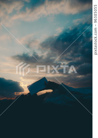 Photo of a young woman lying down and reading a book 96385055