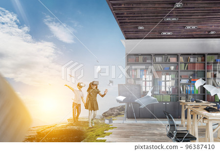 Kids wearing virtual reality goggles 96387410