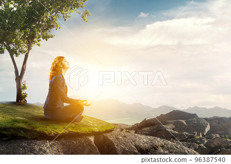 Beautiful businesswoman meditating . Mixed media Beautiful businesswoman meditating . Mixed media 96387540