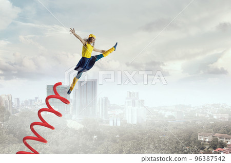 Young woman jumping in the air Young woman jumping in the air 96387542