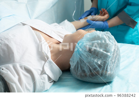 Female patient in operating room at hospital, ready to cesarean section 96388242