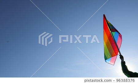 Rainbow LGBT flag waving in the bluesly background soft and selective focus copy space 96388376