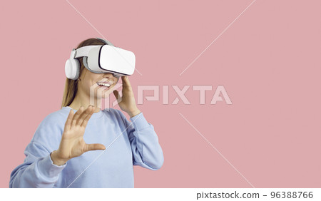 Happy girl on copy space background experiencing virtual reality in her VR headset Happy girl on copy space background experiencing virtual reality in her VR headset 96388766