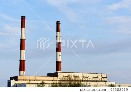 Two factory pipes of a thermal power plant against the blue sky 96388919