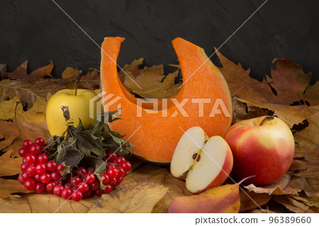 Autumn composition of a piece of pumpkin, apples and red viburnum berries, concept 96389660