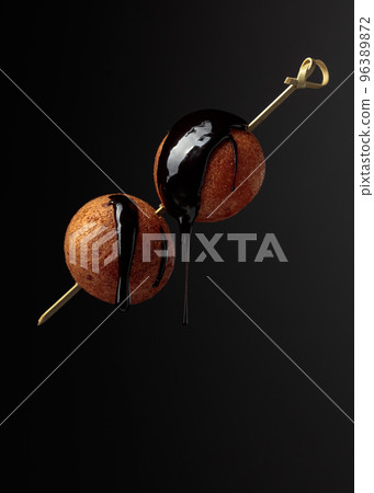 Cottage cheese doughnuts with chocolate sauce on a dark background. 96389872