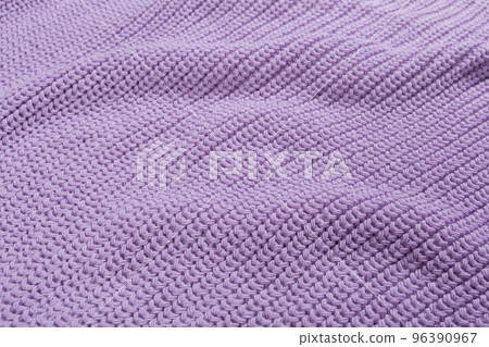 The texture of a lilac knitted fabric, close-up, fabric with folds 96390967