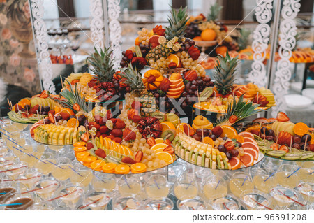 desserts with fruits, mousse, biscuits. Different types of sweet pastries, small colorful sweet cakes, macaron, and other desserts in the sweet buffet. candy bar for birthday 96391208