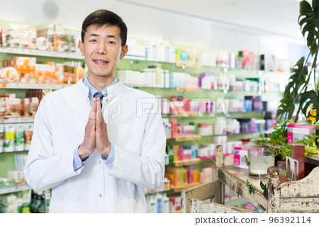 Cheerful korean man is standing with medicines Cheerful korean man is standing with medicines 96392114