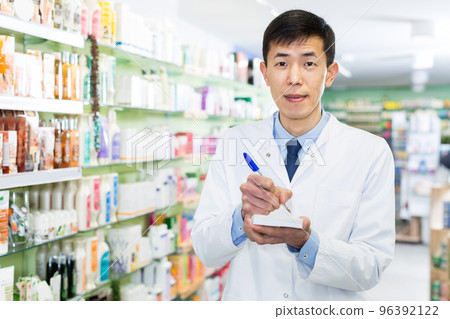 man pharmacist is inventorying medicaments man pharmacist is inventorying medicaments 96392122