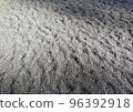 Wave-like sand and pebbles 96392918