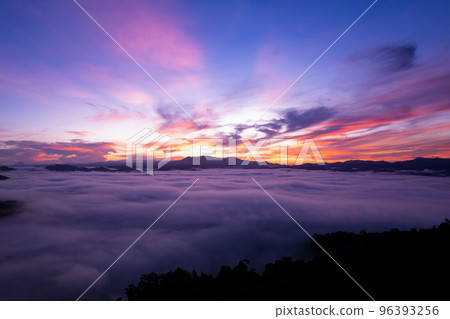Aerial view of flowing fog waves on mountain tropical rainforest,Bird eye view image over the clouds sunrise sky, Amazing nature background with clouds and mountain peaks in Thailand Aerial view of flowing fog waves on mountain tropical rainforest,Bird eye view image over the clouds sunrise sky, Amazing nature background with clouds and mountain peaks in Thailand 96393256