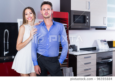middle class smiling family selecting kitchen furniture middle class smiling family selecting kitchen furniture 96393884
