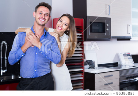 middle class family selecting kitchen furniture middle class family selecting kitchen furniture 96393885