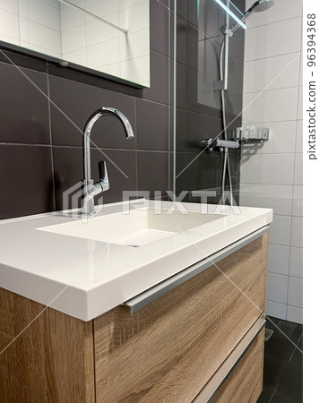 bathroom with white clean bathroom sink and shower stall 96394368