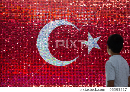 Boy and Turkish national flag with white star and moon 96395317