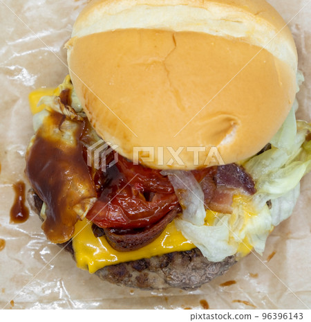Closeup of big beef hamburger with vegetable and ketchup Closeup of big beef hamburger with vegetable and ketchup 96396143
