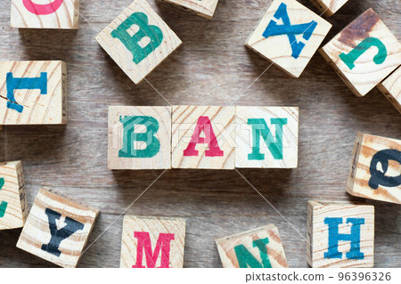 Alphabet letter block in word ban and another letter on wood background Alphabet letter block in word ban and another letter on wood background 96396326