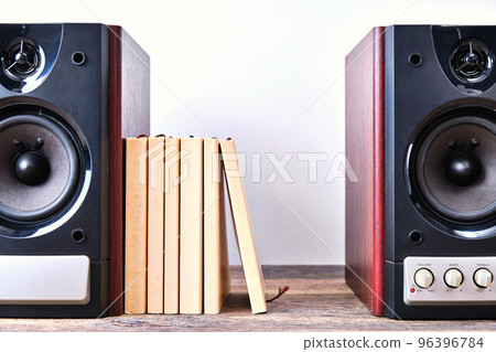 speaker and paperback on wood speaker and paperback on wood 96396784