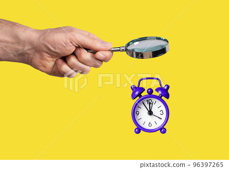 Hand holding magnifying glass over alarm clock. Time management, activities planning, deadline, schedule preparing concept on yellow background. Hand holding magnifying glass over alarm clock. Time management, activities planning, deadline, schedule preparing concept on yellow background. 96397265