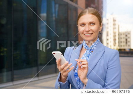 business woman talking on the phone in the background of an office building 96397376