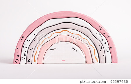 Wooden rainbow stacking toy from arcs. Children sleep concept. Pretty game for toddler in tender pink pastel colors. Hand-eye coordination development. 96397486